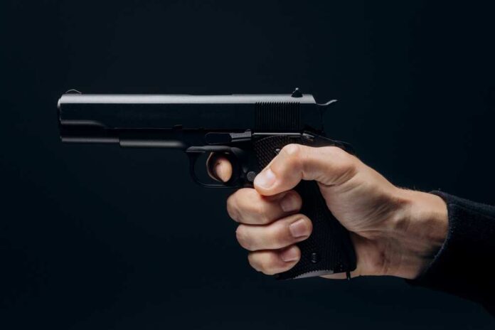 Close,Up,Of,Man,Hand,With,Aiming,Gun,On,A