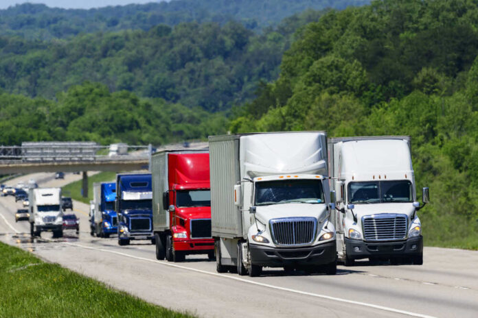 A,Squadron,Of,Eighteen-wheelers,Lead,The,Way,Down,An,Interstate