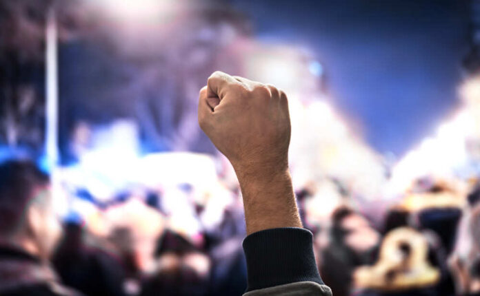 Crowd,Of,People,Protesting.,Protest,,Uprising,,March,Or,Strike,In