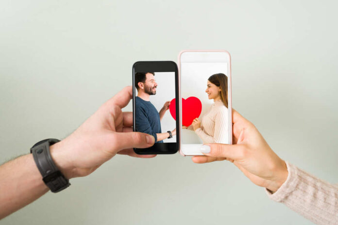 Close,Up,Of,Couple,Joining,Two,Smartphones,Together,With,A