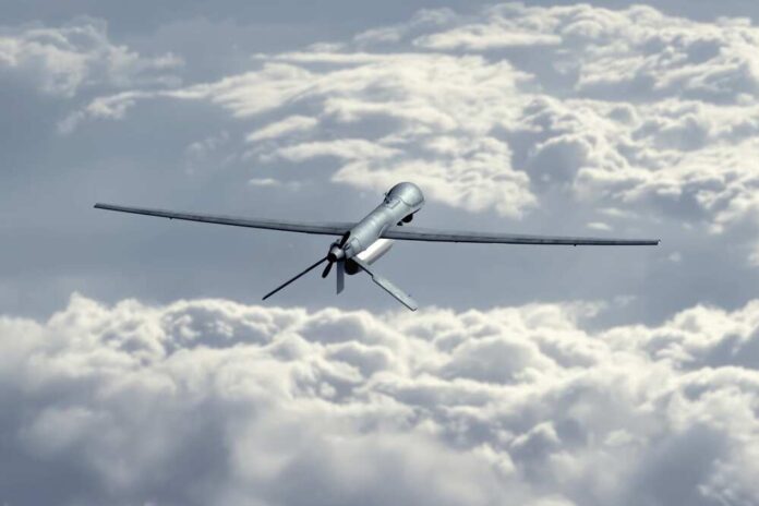 Unmanned,Military,Drone,Flying,In,The,Sky,Above,The,Clouds,