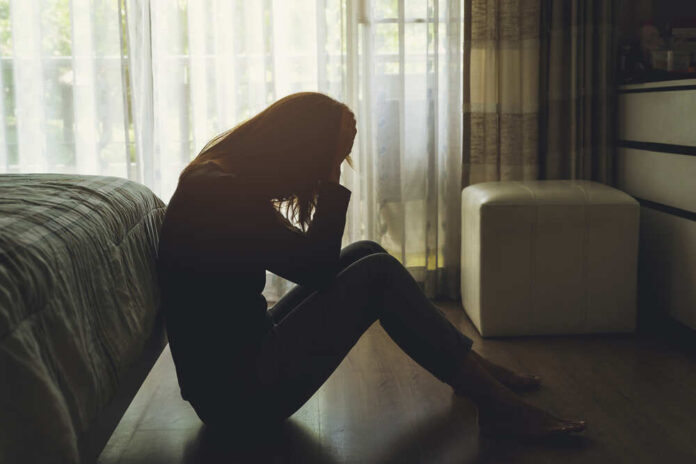 Lonely,Young,Woman,Feeling,Depressed,And,Stressed,Sitting,Head,In