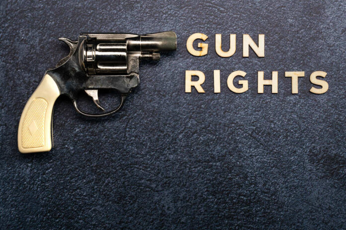 Gun,Rights,Concept,On,A,Blue,Background,With,Text,And