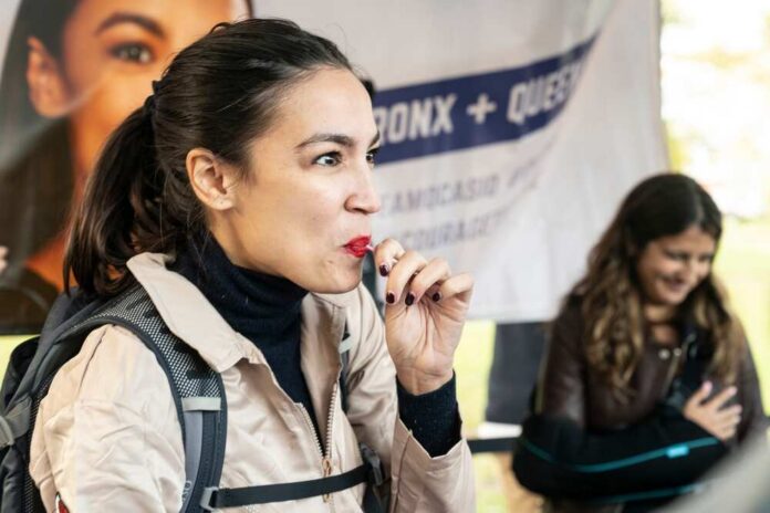 A woman enjoying a snack at an outdoor event with a smiling companion in the background