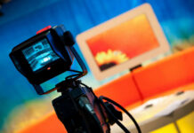 Piers Morgan Cuts Mic on His Own Guest Television camera filming a colorful studio set