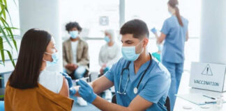 Healthcare worker vaccinating woman in clinic setting