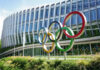 Building with Olympic rings and flags outside