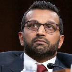 Man in suit and glasses looking thoughtful