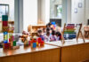 Colorful educational toys in a preschool setting with children in the background