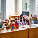Colorful educational toys in a preschool setting with children in the background