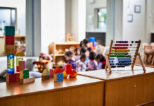 Colorful educational toys in a preschool setting with children in the background