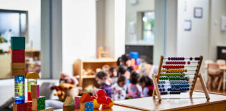 Colorful educational toys in a preschool setting with children in the background
