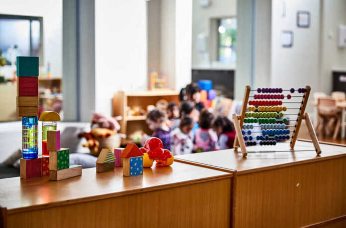 Colorful educational toys in a preschool setting with children in the background