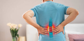 Person experiencing back pain with a visual representation of the spine