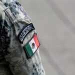 El Mencho’s End: Cartel Fury Unleashed Close-up of a military uniform sleeve featuring the Mexico flag