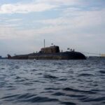 A submarine in the ocean with people on its surface