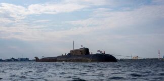 A submarine in the ocean with people on its surface