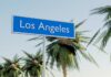 Sign indicating Los Angeles surrounded by palm trees