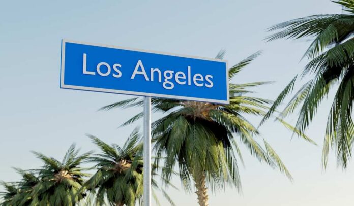 Sign indicating Los Angeles surrounded by palm trees