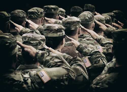 Group of soldiers in uniform saluting during a ceremony