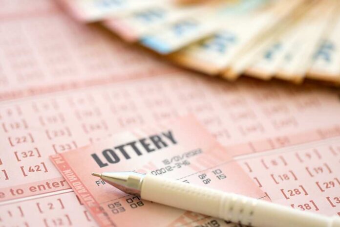 Close-up of lottery tickets and cash with a pen