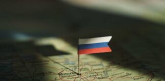 A small Russian flag pinned on a map of Moscow