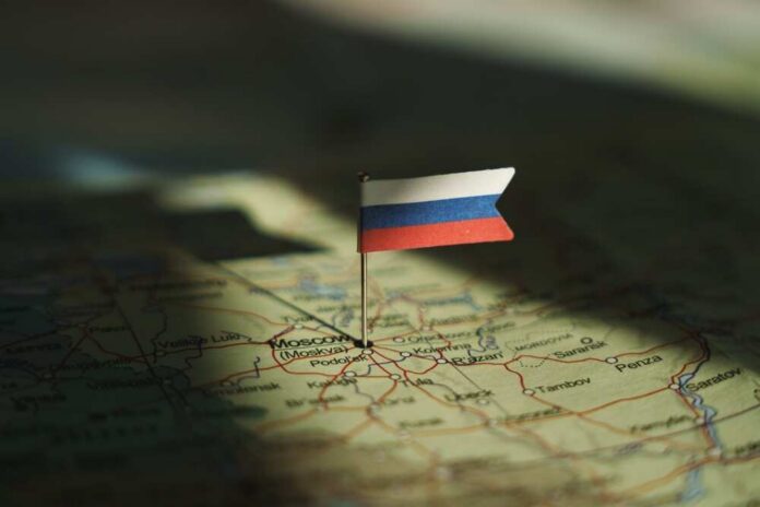 A small Russian flag pinned on a map of Moscow