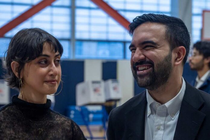 Two individuals engaged in conversation at a polling station
