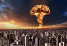 A large mushroom cloud rising over a city skyline at sunset