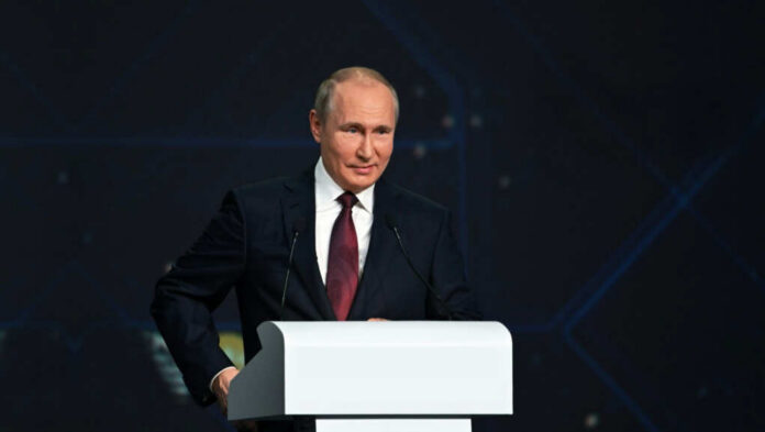 A person speaking at a podium in a suit