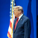 Man in suit with American flag background