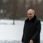 Putin’s Dream Plan: Is NATO Falling Apart? Person in dark coat standing on snowcovered ground
