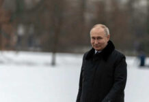 Person in dark coat standing on snowcovered ground