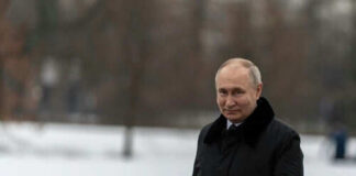 Person in dark coat standing on snowcovered ground