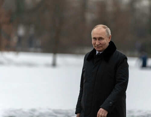 Person in dark coat standing on snowcovered ground