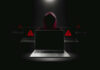 China’s Cyber Advantage EXPOSED – FBI Breach Alarms Hacker in hoodie behind laptops with warning signs