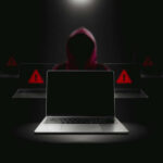 China’s Cyber Advantage EXPOSED – FBI Breach Alarms Hacker in hoodie behind laptops with warning signs