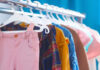 A variety of children's clothing hanging on a rack
