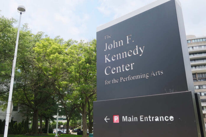 Sign for the John F. Kennedy Center for the Performing Arts with trees in the background