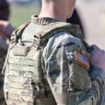 Close-up of a soldier in camouflage uniform with an American flag patch