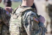Close-up of a soldier in camouflage uniform with an American flag patch