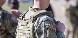 Close-up of a soldier in camouflage uniform with an American flag patch