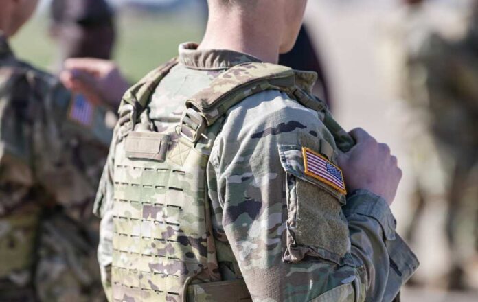 Close-up of a soldier in camouflage uniform with an American flag patch