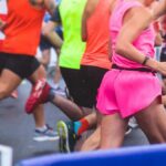 Blind Runner’s AI Glasses Stunt – Revolutionary or Reckless? Runners in colorful athletic wear participating in a race