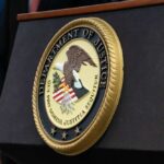 Close-up of the Department of Justice seal on a podium