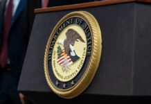 Close-up of the Department of Justice seal on a podium