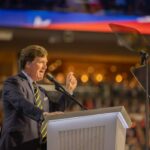 Trump Blasts Former Allies: MAGA Rift Widens A speaker passionately addressing an audience from a podium