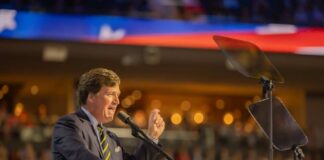 A speaker passionately addressing an audience from a podium