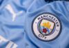 Close-up of a Manchester City football jersey with the team logo