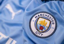 Close-up of a Manchester City football jersey with the team logo